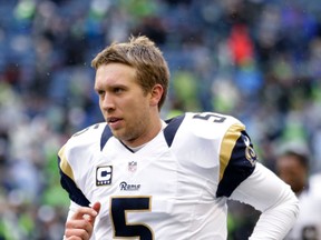 Former St. Louis Rams quarterback Nick Foles running on the field during warmups before an NFL football game against the Seattle Seahawks in Seattle. (AP Photo/Stephen Brashear, File)