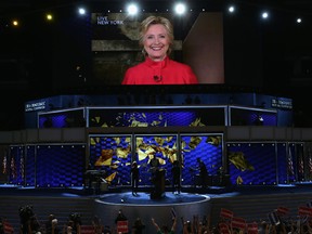 Delegates cheer as a screen displays Democratic presidential candidate Hillary Clinton delivering remarks to the crowd during the evening session on the second day of the Democratic National Convention at the Wells Fargo Center, July 26, 2016 in Philadelphia, Pennsylvania. Democratic presidential candidate Hillary Clinton received the number of votes needed to secure the party's nomination. An estimated 50,000 people are expected in Philadelphia, including hundreds of protesters and members of the media. The four-day Democratic National Convention kicked off July 25. (Photo by Alex Wong/Getty Images)