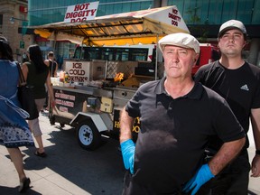 Terry Scanlon, and his son Erik Scanlon, at his Hot Diggity Dog food cart at Bank Street and Laurier Avenue in downtown Ottawa. (Errol McGihon/Postmedia News)