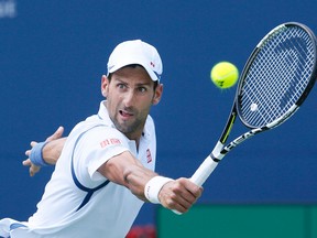 Novak Djokovic returns a shot to Gilles Muller during the Rogers Cup at the Aviva Centre in Toronto Wednesday July 27, 2016. (Stan Behal/Toronto Sun/Postmedia Network)