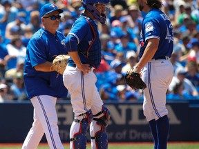 Toornto Blue Jays manager John Gibbons (left) comes to the mound to remove pitcher R.A. Dickey (right) from the game in the sixth inning on July 27, 2016. The San Diego Padres defeated the Blue Jays 8-4. (JACK BOLAND/Toronto Sun)