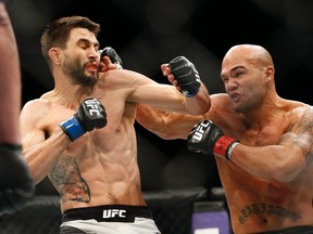 Robbie Lawler (right) is seen here fighting Carlos Condit during a welterweight championship bout at UFC 195 in Las Vegas on Jan. 2, 2016. Lawler faces challenger Tyron Woodley on Saturday at UFC 201 in Atlanta. (John Locher/AP Photo)