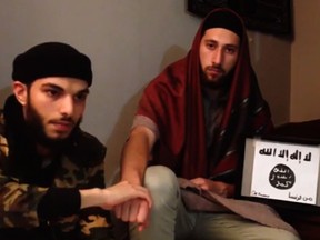 An image grab taken from a video released on July 27, 2016 by Amaq News Agency, an online service affiliated with the Islamic State (IS) group, purportedly shows the two men who stormed into a church in the northern French town of Saint-Etienne-du-Rouvray during morning mass and cut the throat of a 86-year-old priest at the altar, identifying themselves as "Abu Jaleel al-Hanafi"(L) and "Ibn Omar" (R) sitting next to the logo of the Islamic State (IS) group while pledging allegiance to IS leader Abu Bakr al-Baghdadi.  (AMAQ NEWS AGENCY/AFP/Getty Images)