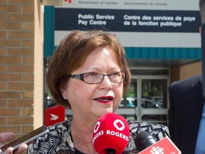 Public Services Minister Judy Foote speaks to the media in Miramichi, N.B., on Wednesday, July 27, 2016. Public Services Minister Judy Foote is laying some blame for problems with the government's new Phoenix payroll system on a lack of training for staff who input information within each federal department. Foote toured the centralized pay centre in Miramichi, N.B., and met with employees on Wednesday. (Ron Ward, The Canadian Press)