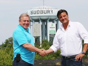 Gates Perreault, left, of the Adaptive Canuck ALS Foundation, shakes hands with Dario Zulich, CEO of TESC Contracting, in front of the water tower in Sudbury, Ont. on Wednesday July 27, 2016. Zulich announced at a press conference that he has bought the water tower and included an $80,000 donation to the Adaptive Canuck ALS Foundation as part of the purchase agreement. Perreault's son, Jeff, has ALS and was a former owner of the water tower. John Lappa/Sudbury Star/Postmedia Network