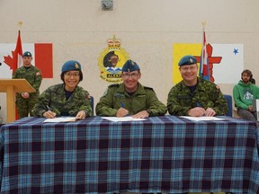 2nd Lt. Cory Watson, DND-MDN Canada
From left to right are  Maj. Amy Tsai-Lamoureux, incoming Commanding Officer of Canadian Forces Station Alert, Lt. Col. Steve Camps, 8 Wing Operations Officer, and outgoing Commanding Officer Maj. Rob Snow signing the ceremonial certificates marking the official change of command on July 27.