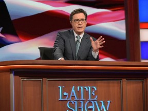 In this July 27, 2016 photo released by CBS, Stephen Colbert, host of "The Late Show with Stephen Colbert," appears during a broadcast in New York. Lawyers representing his old show company complained to CBS after Colbert revived the character he played under his own name on “The Colbert Report,"  a clueless, full-of-himself cable news host.  (Scott Kowalchyk/CBS via AP)