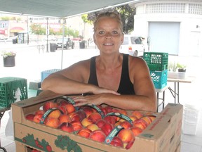 Lisa Davis from Napanee was at a stall at the downtown farmers' market in Kingston, Ont. on Thursday, July 28, 2016. Local farmers and their crops are feeling the effects of the hot dry days this summer. Michael Lea The Whig-Standard Postmedia Network