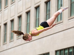 Emma Boswell catches some air during a SpringAction trampoline show during 25th Annual Ottawa International Buskerfest along Sparks Street. in Ottawa Thursday July 28, 2016. (Darren Brown/Postmedia News)
