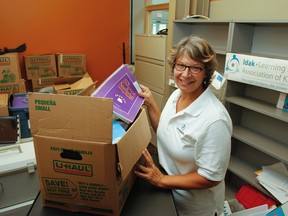 Lynn Sadlowski, president of the Learning Disabilities Association Kingston, starts to unpack in the association's new office space at 817 Division St. in the Family and Children's Services building in Kingston. The not-for-profit agency will officially opening its doors on Sept. 6 as well as celebrate its 35th anniversary. (Julia McKay/The Whig-Standard)
