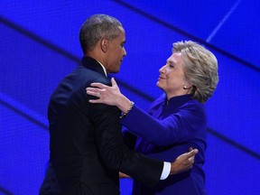 US President Barack Obama and Democratic presidential nominee Hillary Clinton embrace on  stage during Day 3 of the Democratic National Convention at the Wells Fargo Center, July 27, 2016 in Philadelphia, Pennsylvania.      / AFP PHOTO / SAUL LOEBSAUL LOEB/AFP/Getty Images