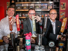 Alberta Minister of Agriculture and Forestry Oneil Carlier, left, Terry Rock, Alberta Small Brewers Association and  Minister of Finance and Treasury Board president Joe Ceci toast the new subsidies announced for small breweries at Village Brewery in Calgary, Ab., on Thursday July 28, 2016. Mike Drew/Postmedia