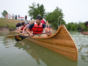 Chippewas of the Thames First Nation youth Kingston Huff paddles away from shore in a canoe, which he helped build, at a naming and launch ceremony at the Sharon Creek Conservation Area southwest of London Thursday. (CRAIG GLOVER, The London Free Press)