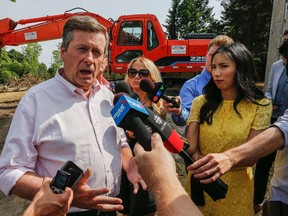 Mayor John Tory speaks with media on scene at Bayview Ave. south of York Mills Rd. in Toronto where it is believed that a developer cut down 30 mature trees, some over 100 years old without getting a permit on Thursday July 28, 2016. Dave Thomas/Toronto Sun/Postmedia Network