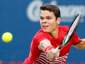 Milos Raonic returns a shot to Jared Donaldson during the Rogers Cup at the Aviva Centre at York University Thursday, July 28, 2016. (Stan Behal/Toronto Sun/Postmedia Network)