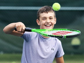 Tate Wilkins, 12, laughs during a volleying drill at the Chatham Tennis Club's junior lessons in Chatham, Ont., on Thursday, July 28, 2016. (MARK MALONE/Chatham Daily News/Postmedia Network)