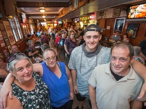 The Moynahan family including Mandala (from left), her sister Meghan Gaines, her son Drew and husband Corey were one of the families affected by fire in Mechanicsville gathered with friends, family and supporters at the Carleton Tavern as the Mechanicsville Community Association and the Hintonburg Economic Development Committee host a fundraiser for the families who were affected by this fire.