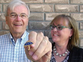 Bill and Katy Adams and his blue umbrella pin which promotes the new Dementia Friendly Community program of the Alzheimer Society Elgin-St Thomas.