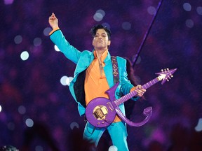 In this Feb. 4, 2007 file photo, Prince performs during the halftime show at the Super Bowl XLI football game at Dolphin Stadium in Miami. Prince’s family says an official tribute concert honoring the late icon will take place on October 13, at the U.S. Bank Stadium in Minneapolis. (AP Photo/Chris O'Meara, File)