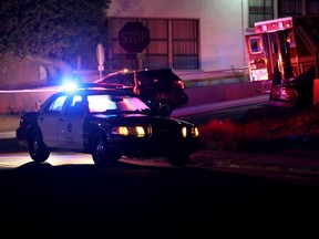 San Diego police and other law enforcement stage near the scene of a shooting of two San Diego police officers near South 38th Street in San Diego Thursday night, July 28, 2016. (John Gastaldo/The San Diego Union-Tribune via AP)