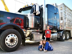 Perth Care for Kids held its 6th annual Big Wheel Little Drivers event in the Mitchell & District Arena parking lot July 23, where kids of all ages got a chance to get a closer look at some of the big vehicles from all over West Perth. Pictured, Piper and Mya Thomson, and Liam Hunt pose for a picture with an enormous (by comparison) livestock truck. In total, organizers guessed that 450 people attended despite the hot, humid weather conditions. After all, who can resist a big truck? GALEN SIMMONS/MITCHELL ADVOCATE