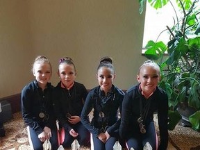 The four girls show the awards they won at nationals and the worlds. The team from Studio 89 placed in 15 of their 18 dance routines. - Photo supplied