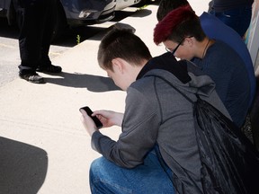 Youth playing Pokémon Go in Stony Plain last week.  - Photo by Marcia Love