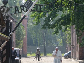 Pope Francis walks through the gate of the former Nazi German death camp of Auschwitz in Oswiecim, Poland, Friday, July 29, 2016. Pope Francis paid a somber visit to the Nazi German death camp of Auschwitz-Birkenau Friday, becoming the third consecutive pontiff to make the pilgrimage to the place where Adolf Hitler's forces killed more than 1 million people, most of them Jews. (AP Photo/Czarek Sokolowski)