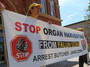 Tim Miller/The Intelligencer
Practitioners of Falun Gong gathered in front of Belleville city hall on Friday July 29, 2016 in Belleville, Ont. The Toronto-based group has been visiting cites across Ontario to spread the word about forced organ harvesting in China.