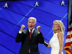 Vice President Joe Biden pumps his arms as he walks off the stage with his wife Dr. Jill Biden after speaking to delegates during the third day session of the Democratic National Convention in Philadelphia, Wednesday, July 27, 2016. (AP Photo/Carolyn Kaster)
