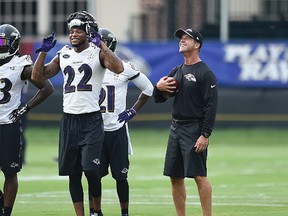 Baltimore Ravens head coach John Harbaugh, right, smiles during practice at NFL training camp in Owings Mills, MD., on July 28, 2016. (AP Photo/Gail Burton)