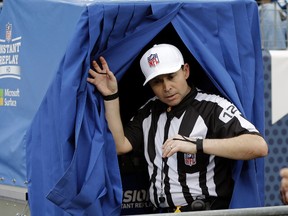 In this Dec. 27, 2015, file photo, referee Brad Allen leaves the instant replay booth after reviewing a play in the second half of an NFL football game between the Tennessee Titans and the Houston Texans, in Nashville. (AP Photo/James Kenney, File)