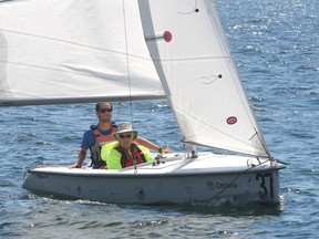 Able Sail student David Turner, front, and instructor Ira Carson sail on Lake Ontario, off Kingston, Ont. on Wednesday, July 27, 2016. The Able Sail program, out of the Kingston Yacht Club, allows people with mobility issues to sail a special adapted sailboat. Michael Lea The Whig-Standard Postmedia Network
