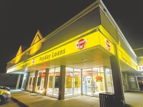 Some payday loan businesses keep late hours to provide clients with quick cash. But instead of just lowering short-term interest rates, Ontario could help its poorer residents by raising the minimum wage to about $15 an hour. (Postmedia Network file photo)