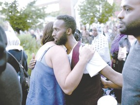 Abdiaziz Abdi is embraced Tuesday during a memorial in Ottawa for his brother. Abdirahman Abdi, 37, a Somali-Canadian with mental health issues, died after an altercation with Ottawa police. Letter-writer Gary Wilson doesn?t believe police are the right people to respond to the mentally ill. (Justin Tang/The Canadian Press)