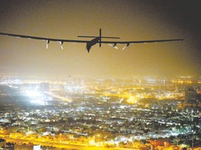 Solar Impulse 2, a solar-powered aircraft piloted by Swiss pioneer Bertrand Piccard, approaches Abu Dhabi, in the United Arab Emirates, Tuesday as it completes its epic journey to become the first sun-powered airplane to circle the globe without a drop of fuel. (JEAN REVILLARD/AFP/Getty Images)