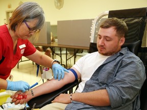 Luke Hendry/Intelligencer file photo
Canadian Blood Services phlebotomist Keiko Hattori collects blood from Kyle Boutilier of Belleville during a donation clinic at the Belleville Fish and Game Club Monday, July 6, 2015.