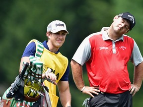 Patrick Reed and caddie Kessler Karain wait on the seventh hole during the second round of the 2016 PGA Championship at Baltusrol Golf Club on July 29, 2016 in Springfield, N.J.  (Stuart Franklin/Getty Images)
