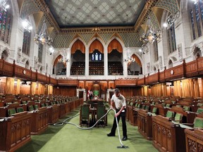 A maintenance worker uses a vacuum to clean and prepare the House of Commons at Parliament Hill in Ottawa in this Sept 14, 2012 file photo. (ANDRE FORGET/Postmedia Network files)