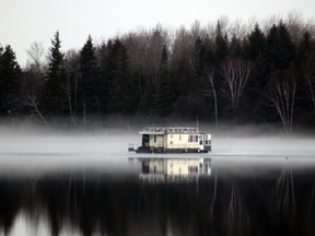 Mist rising off Lake of the Woods shrouds a houseboat still ice bound at its winter moorage site in a bay off Coney Island on Thursday, April 14, 2016.Reg Clayton/Kenora Daily Miner and News/Postmedia Network