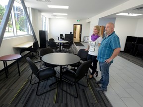Pathway employees Melissa Power and Neil Suter admire the main lobby at the new location for Pathways Skills Development on Horton Street. With the new space, staff won?t have to shuttle between two sites. (MORRIS LAMONT, The London Free Press)