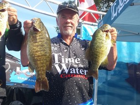 Orillia's John Whyte, with amateur Tim Hunter, a teacher at Holy Cross Secondary School, bagged the day's big fish, a whopping 5.80-pound smallmouth, at the Kingston Canadian Open on Friday. (Doug Graham/The Whig-Standard)
