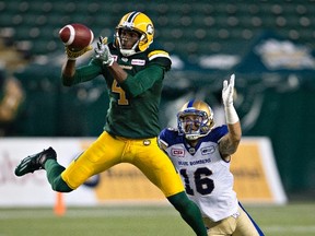 Winnipeg Blue Bombers' Taylor Loffler (16) chases Edmonton Eskimos' Adarius Bowman (4) as he makes the catch during second half CFL action in Edmonton, Alta., on Thursday July 28, 2016.