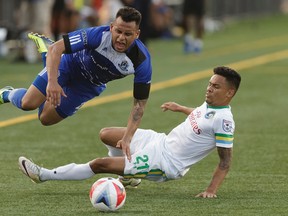 Edmonton's Shawn Nicklaw (22) and New York's David Diosa (21) collide during NASL soccer play between FC Edmonton and the New York Cosmos at Clarke Stadium in Edmonton, on Wednesday, July 27, 2016.