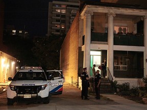 Police tend to the scene of a fatal stabbing on Charles St. near Church St. late Friday night. John Hanley/FREELANCE