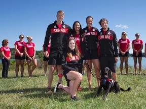 Canadian Paralympic para-rowers Kristen Kit, front, Curtis Halladay, Andrew Todd, Meghan Montgomery and Victoria Nolan, with her guide dog Alan, are introduced to members of the media at the Doug Wells Rowing Centre at Fanshawe Lake in London, Ont. on Tuesday July 26, 2016. Members of the Olympic rowing team, pictured in back, were on hand to show their support for the athletes heading to Rio.  Craig Glover/The London Free Press/Postmedia Network