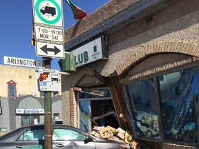 A car crashed into the side of a building at the corner of Arlington and Sargent on Saturday morning. (Glen Dawkins/Winnipeg Sun/Postmedia Network)