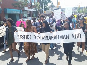 Protesters head east along Somerset Street West en route to police headquarters on Saturday, July 30.