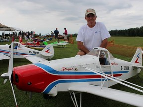 Karl Gross, of Burlington, poses with his model Hanger 9 Piper -- complete with a pilot modeled on himself -- at the annual Bluewater R/C Flyers' rally held Saturday. Twenty pilots -- from as far away as Michigan and Kitchener -- were registered to fly in the 39th annual event held at the Bluewater club's flying field on Petrolia Line. Barbara Simpson/Sarnia Observer/Postmedia Network