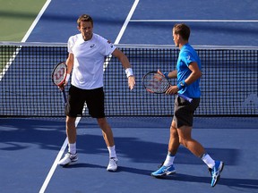 Daniel Nestor (left) and Vasek Pospisil (right) of Canada react during their doubles semifinal match against Jamie Murray of Great Britain and Bruno Soares of Brazil at the Rogers Cup in Toronto on Saturday, July 30, 2016. (Vaughn Ridley/Getty Images)